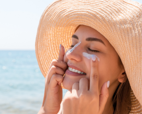 Mujer usando crema solar en el Rostro